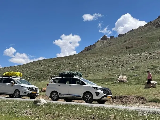 Real white Innova Crysta vehicles travelling through the Spiti mountains